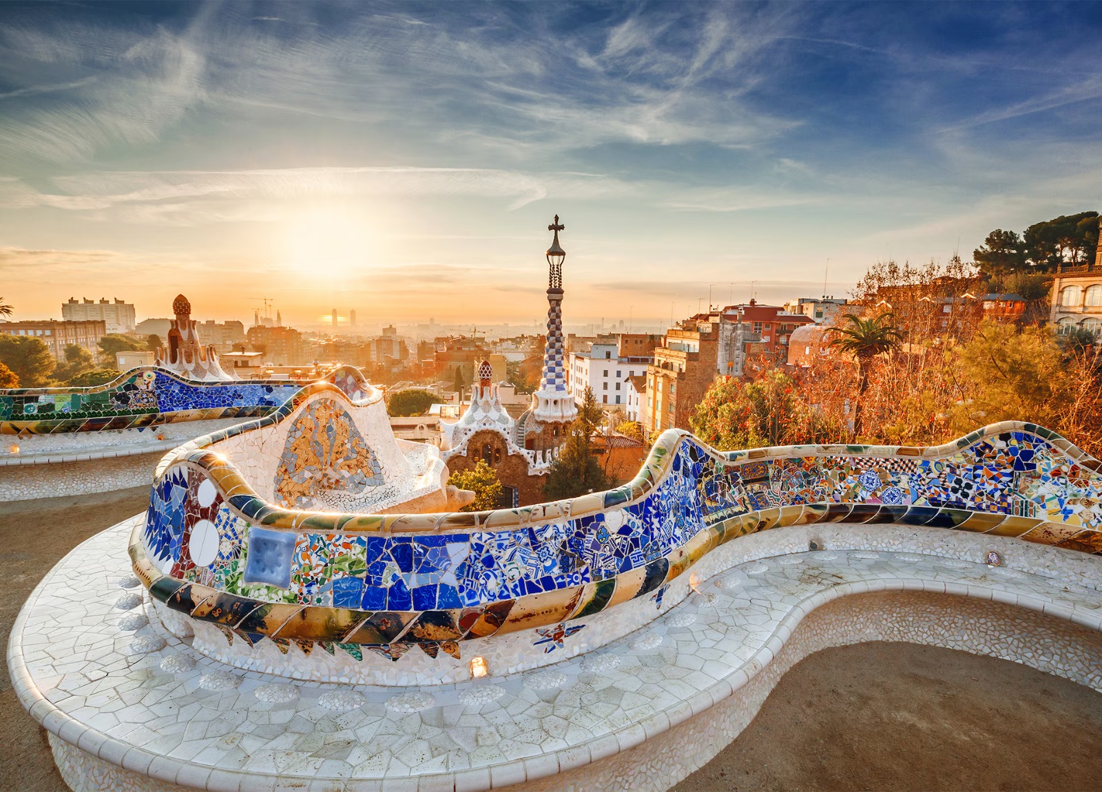 Park Güell mosaic terrace overlooking Barcelona at sunrise